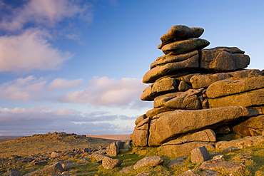 Late afternoon sunlight glows on the granite rock formations of Great Staple Tor in Dartmoor National Park, Devon, England, United Kingdom, Europe