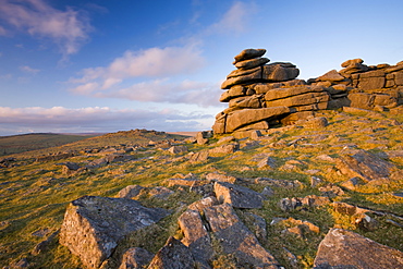 Late afternoon sunlight glows on the granite rock formations of Great Staple Tor in Dartmoor National Park, Devon, England, United Kingdom, Europe