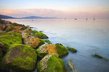 Pastel sunset over the Dorset cliffs, as seen from Lyme Regis, Dorset, England, United Kingdom, Europe