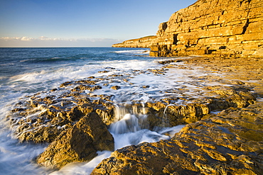 Incoming tide splashes on the ledges at Seacombe on the Jurassic Coast, UNESCO World Heritage Site, Dorset, England, United Kingdom, Europe