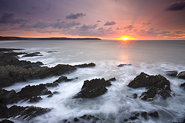 Sun setting over the Atlantic, viewed from Woolacombe Bay in Devon, England, United Kingdom, Europe