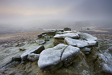 Frost covered granite outcrop on Hookney Tor, with thick fog descended over the moorland landscape, Dartmoor National Park, Devon, England, United Kingdom, Europe