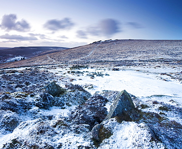 Snow covered stone hut circles in Bronze Age settlement of Grimspound in Dartmoor National Park, Devon, England, United Kingdom, Europe