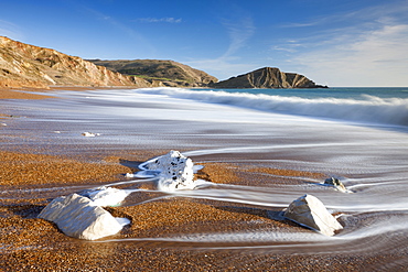 Waves wash clean the beautiful beach at Worbarrow Bay on the Jurassic Coast, UNESCO World Heritage Site, Dorset, England, United Kingdom, Europe