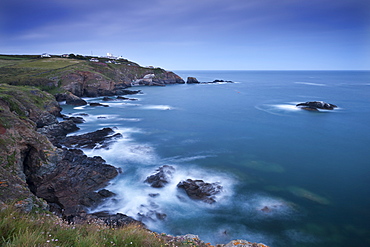 View from Lizard Point over rocky Polpeor Cove and onto the Lizard Lighthouse and old Lifeboat Station, Lizard, Cornwall, England, United Kingdom, Europe