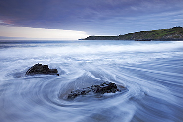 Waves rush onto the beach at Kennack Sands, Lizard Peninsula, Cornwall, England, United Kingdom, Europe