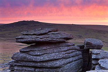 Colourful dawn sky above Great Mis Tor, viewed from the granite outcrops of Great Staple Tor, Dartmoor National Park, Devon, England, United Kingdom, Europe