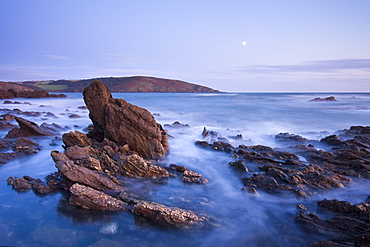 Moon rising above the rocky shores of Wembury Bay at twilight, Devon, England, United Kingdom, Europe