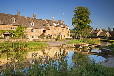 Cottages beside the River Eye in the picturesque Cotswold village of Lower Slaughter, Gloucestershire, England, United Kingdom, Europe