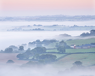 Farmhouse and mist covered countryside, Stockleigh Pomeroy, Devon, England, United Kingdom, Europe