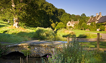 Picturesque farmhouses beside the River Eye in the Cotswolds village of Upper Slaughter, Gloucestershire, England, United Kingdom, Europe 