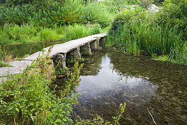 Clapper bridge crossing the River Leach in the pretty Cotswolds village of Eastleach Turville, Gloucestershire, England, United Kingdom, Europe 