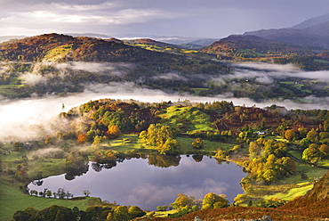 Loughrigg Tarn surrounded by misty autumnal countryside, Lake District National Park, Cumbria, England, United Kingdom, Europe 