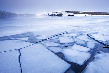 Broken ice on the surface of Llyn y Fan Fawrm, surrounded by hill fog, Black Mountain, Brecon Beacons National Park, Wales, United Kingdom, Europe 