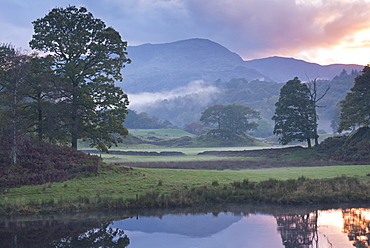 Atmospheric autumn sunset from the River Brathay near Elterwater, Lake District, Cumbria, England, United Kingdom, Europe 