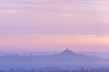 Glastonbury Tor rising surrounded by mist at dawn in summer, Somerset, England, United Kingdom, Europe 