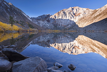 Early morning sunshine lights the Eastern Sierra Mountains beyond Convict Lake, California, United States of America, North America