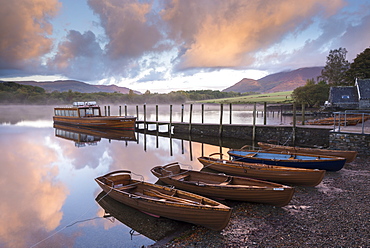 Boats moored on Derwent Water at dawn in autumn, Keswick, Lake District, Cumbria, England, United Kingdom, Europe