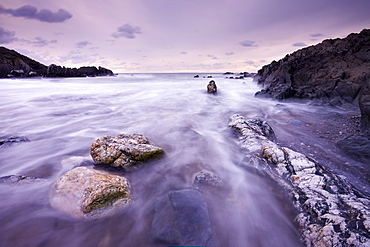 Surging tide at twilight, Coombesgate Beach, Woolacombe, Devon, England, United Kingdom, Europe