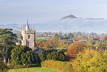 Glastonbury Tor and West Pennard Church on a misty autumn morning, Somerset, England, United Kingdom, Europe