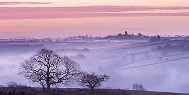 Mist shrouded countryside looking towards the village of Morchard Bishop in winter, Devon, England, United Kingdom, Europe