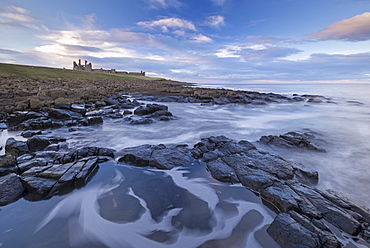 Rocky shores below Dunstanburgh Castle, Craster, Northumberland, England, United Kingdom, Europe