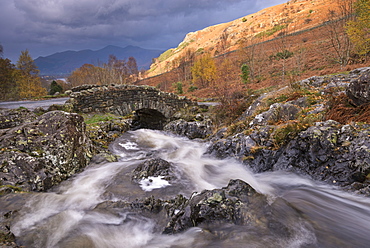 Rocky stream tumbling under Ashness Bridge in autumn, Lake District National Park, Cumbria, England, United Kingdom, Europe