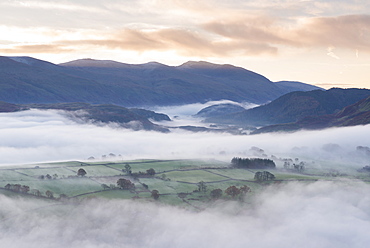 Mist covered rolling landscape at dawn in autumn, Lake District, Cumbria, England, United Kingdom, Europe