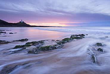 Sunrise over Mumbles Lighthouse from Bracelet Bay in winter, Swansea, Wales, United Kingdom, Europe