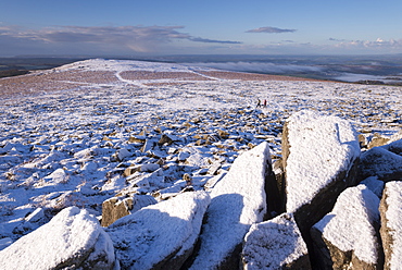 Walkers in winter on snow covered moorland near Sharpitor, Dartmoor National Park, Devon, England, United Kingdom, Europe