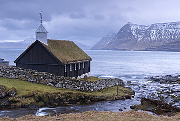 Grass roofed Church in the village of Funningur in winter on the island of Eysturoy, Faroe Islands, Denmark, Europe
