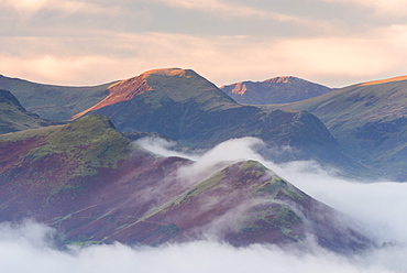 Catbells mountain surrounded by morning mist in autumn, Lake District National Park, Cumbria, England, United Kingdom, Europe