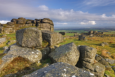 Early morning sunlight illuminates the granite rocks of Rowtor in the north of Dartmoor National Park, Devon, England, United Kingdom, Europe