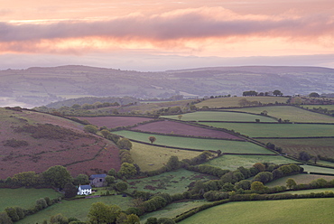 Colourful sunrise over Quintatown farm and the rolling fields of Dartmoor National Park near Chagford, Devon, England, United Kingdom, Europe