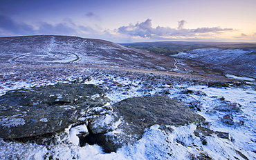 Bronze Age walled settlement of Grimspound, isolated in a snow covered moorland wilderness, viewed from Hookney Tor overlook, Dartmoor National Park, Devon, England, United Kingdom, Europe