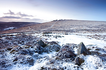 Snow covered stone hut circles in Bronze Age settlement of Grimspound in Dartmoor National Park, Devon, England, United Kingdom, Europe