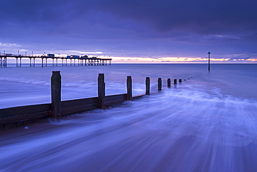 Waves rush over the beach at Teignmouth at dawn in winter, Devon, England, United Kingdom, Europe