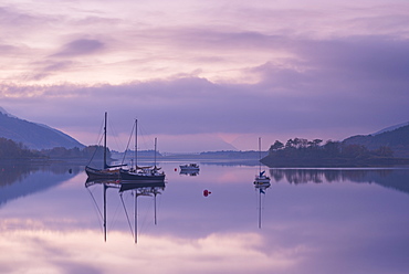 Yachts moored on a tranquil Loch Leven at twilight, Glencoe, Highland, Scotland, United Kingdom, Europe