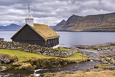 Traditional grass roofed Faroese church in the village of Funningur on the island of Eysturoy, Faroe Islands, Denmark, Europe