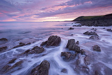 Colourful sunset above Manorbier Beach on the Pembrokeshire coast, Wales, United Kingdom, Europe