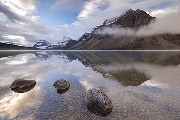 Mirror still Bow Lake at dawn on the Icefields Parkway, Banff National Park, UNESCO World Heritage Site, Canadian Rockies, Alberta, Canada, North America