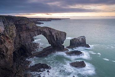 Sunrise over the Green Bridge of Wales, Castlemartin, Pembrokeshire, Wales, United Kingdom, Europe