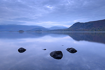 Reflections on a tranquil Derwent Water at dusk, Lake District National Park, Cumbria, England, United Kingdom, Europe