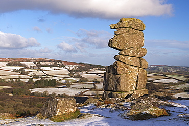 The Bowerman's Nose granite pillar surrounded by light winter snow, Dartmoor, Devon, England, United Kingdom, Europe