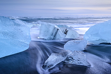 Blue ice washed upon a black sand beach, Jokulsarlon, Iceland, Polar Regions