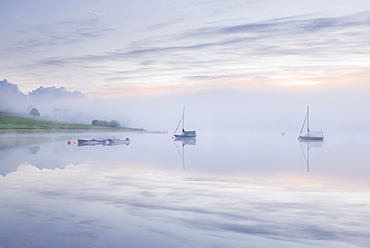 Sunrise on a misty morning on Wimbleball Reservoir, Exmoor National Park, Somerset, England, United Kingdom, Europe