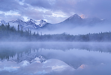 Canadian Rockies and mist reflected in Herbert Lake at sunrise, Banff National Park, UNESCO World Heritage Site, Alberta, Canada, North America