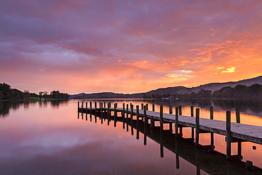 Spectacular colourful sunset above one of Lake Coniston's wooden jetties, Lake District, UNESCO World Heritage Site, Cumbria, England, United Kingdom, Europe