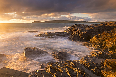 Golden evening light bathes the rocky shores near Constantine Bay in North Cornwall, England, United Kingdom, Europe