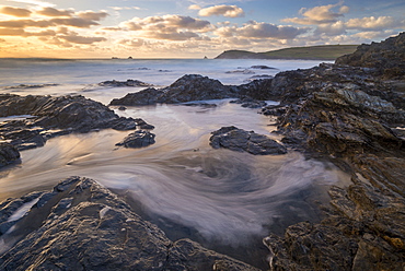 Swirling waves on the rocky shores of Booby's Bay near Trevose Head at sunset, Cornwall, England, United Kingdom, Europe